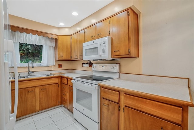 kitchen with light tile patterned flooring, sink, and white appliances