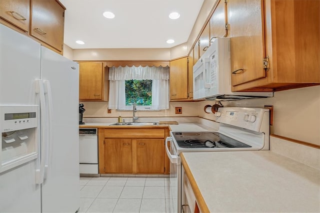 kitchen with white appliances, sink, and light tile patterned floors