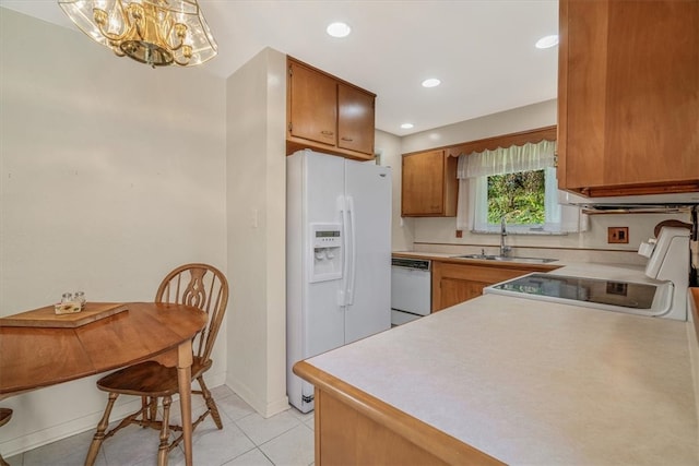 kitchen featuring light tile patterned floors, sink, and white appliances