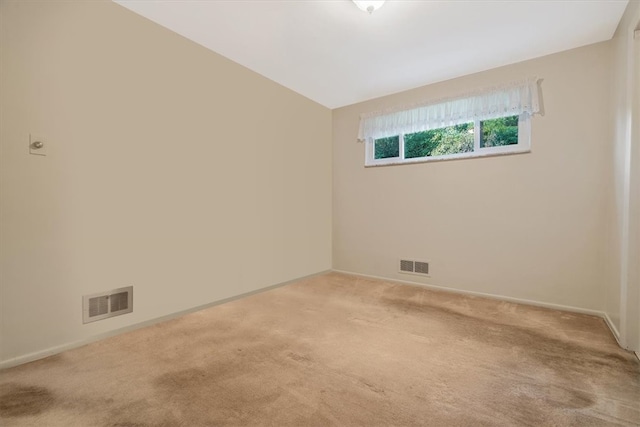 carpeted spare room with vaulted ceiling