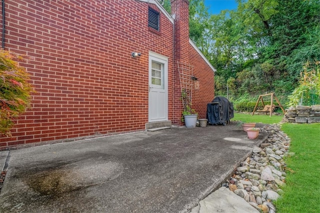 view of home's exterior featuring a playground, a yard, and a patio area