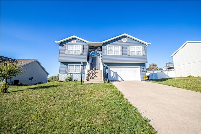 split foyer home featuring a garage and a front lawn