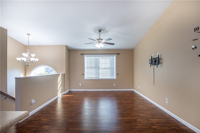 unfurnished room featuring ceiling fan with notable chandelier and dark hardwood / wood-style flooring