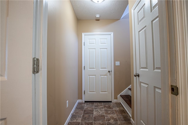 entryway with a textured ceiling