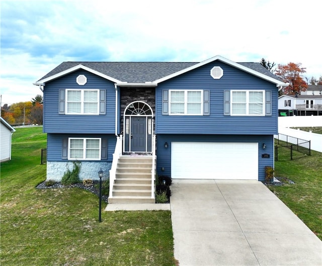 bi-level home featuring a front yard and a garage