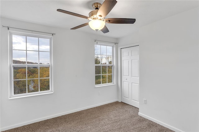 unfurnished room featuring light carpet and ceiling fan