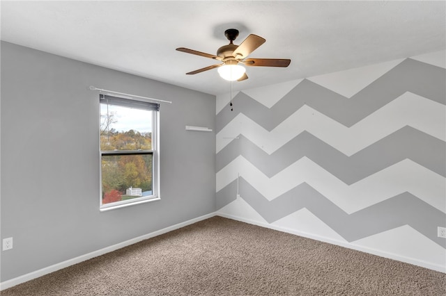 spare room featuring carpet flooring and ceiling fan