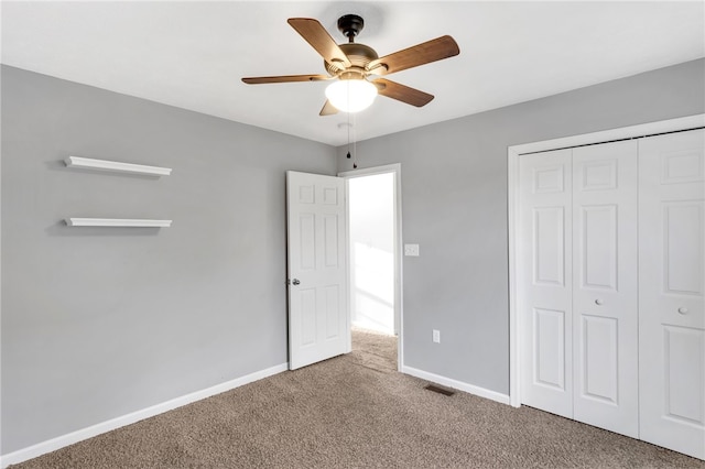 unfurnished bedroom with carpet, a closet, and ceiling fan