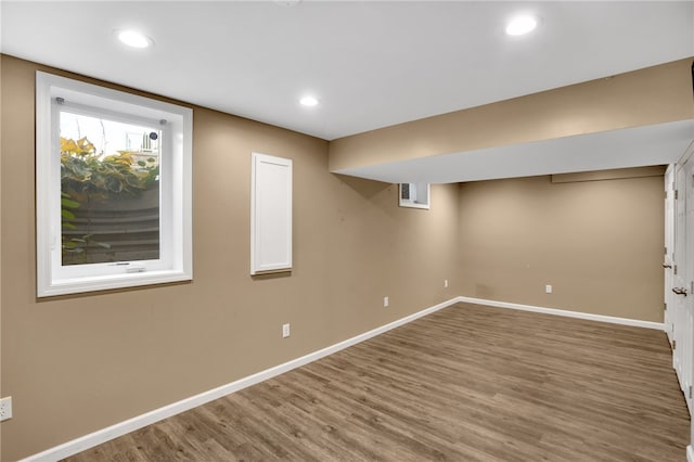 basement with hardwood / wood-style floors