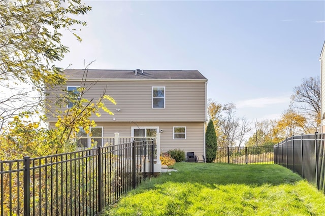 back of property featuring a yard and central AC unit