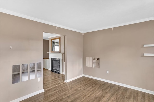 spare room with ornamental molding and hardwood / wood-style flooring