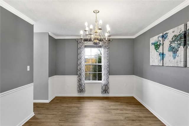 unfurnished dining area featuring crown molding, dark hardwood / wood-style floors, a chandelier, and a textured ceiling