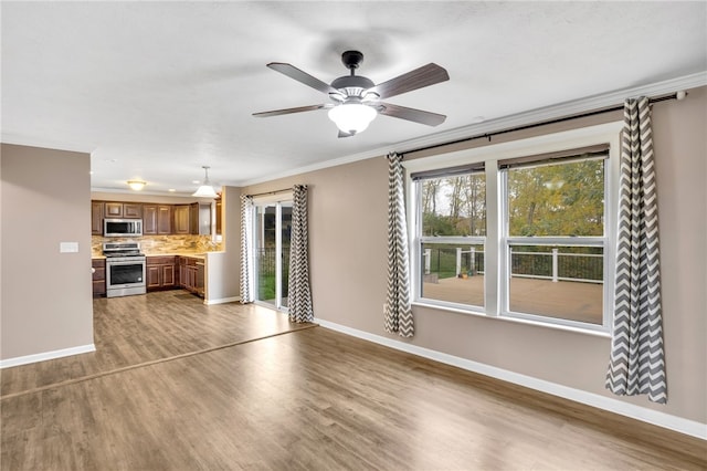 unfurnished living room with ornamental molding, hardwood / wood-style flooring, and ceiling fan