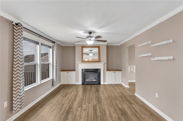 unfurnished living room featuring crown molding, wood-type flooring, and ceiling fan