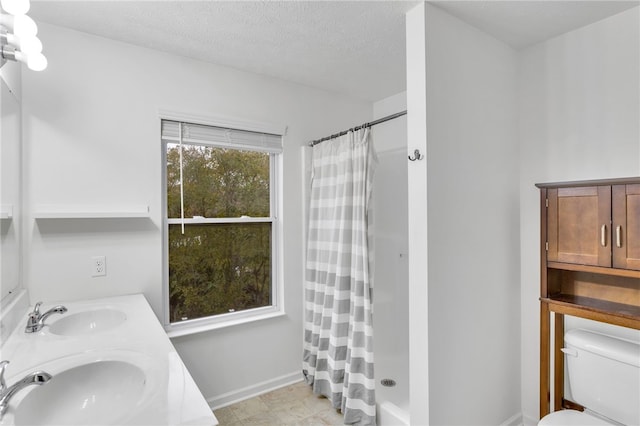 bathroom with toilet, a textured ceiling, vanity, and a shower with shower curtain