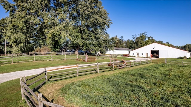 view of yard with a rural view and an outbuilding