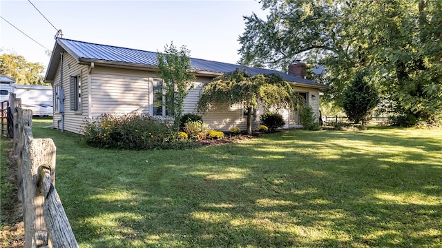 view of side of property with a yard