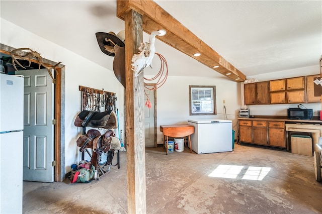 kitchen featuring beamed ceiling, fridge, and white refrigerator