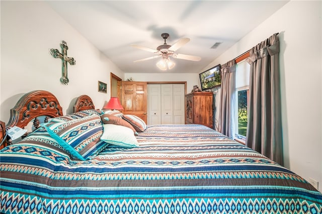 bedroom with ceiling fan and a closet