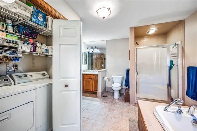 washroom with washer and dryer, sink, and a textured ceiling