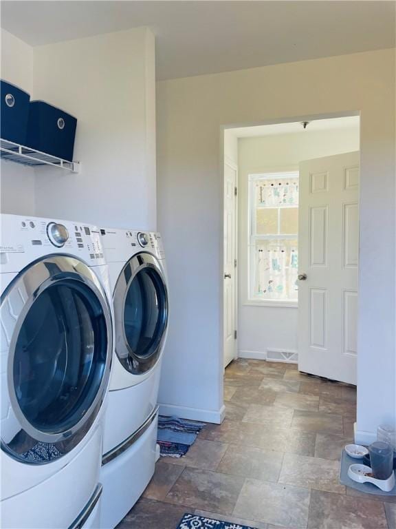 409 Ceylon Rd, Carmichaels/Cumblnd, PA 15320 - laundry room featuring washer and clothes dryer, stone finish floors, and baseboards