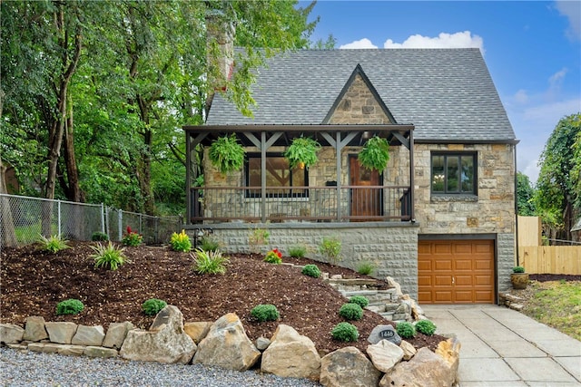 tudor-style house featuring a garage