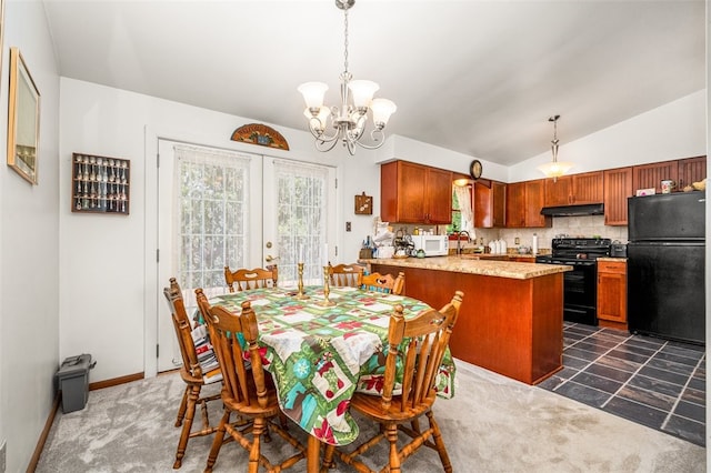 dining area with lofted ceiling, sink, a chandelier, and french doors