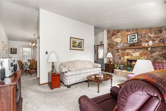 living room with lofted ceiling, light colored carpet, a chandelier, and a stone fireplace