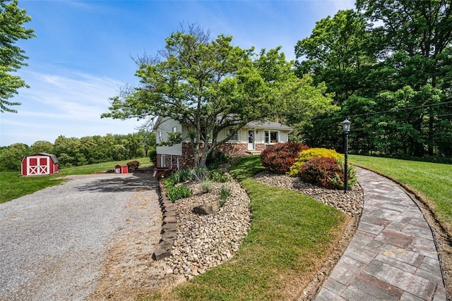 view of front of house with a front yard and a shed