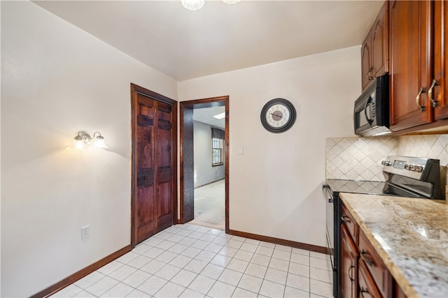 kitchen featuring light tile patterned floors, backsplash, and electric stove