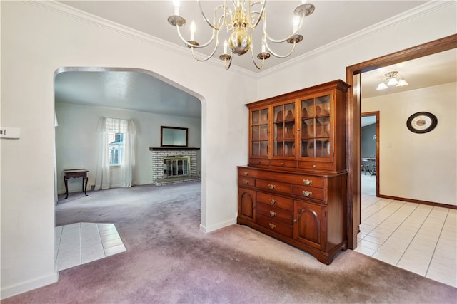 dining area featuring a brick fireplace, light carpet, and ornamental molding