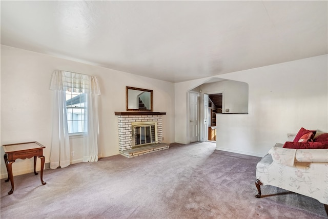 sitting room with carpet floors and a fireplace