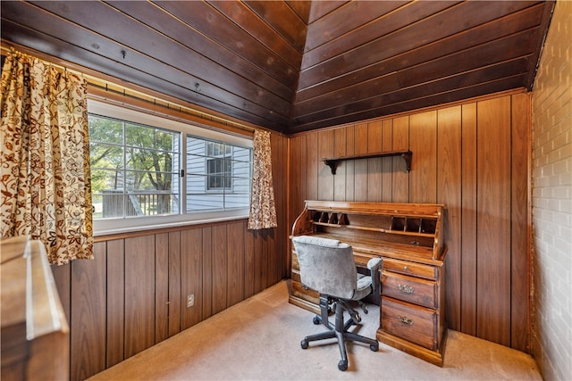 office with wood walls, brick wall, and carpet flooring