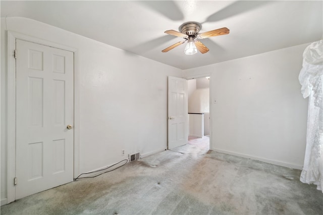 unfurnished bedroom with ceiling fan and light colored carpet