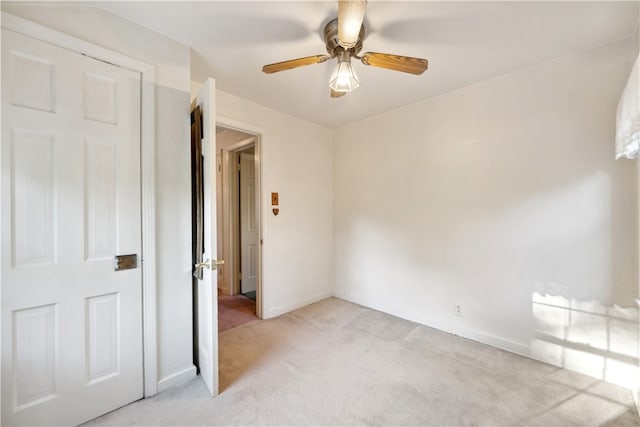 unfurnished bedroom with light carpet and ceiling fan