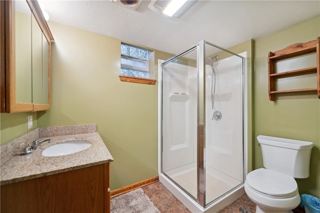 bathroom with toilet, vanity, and walk in shower