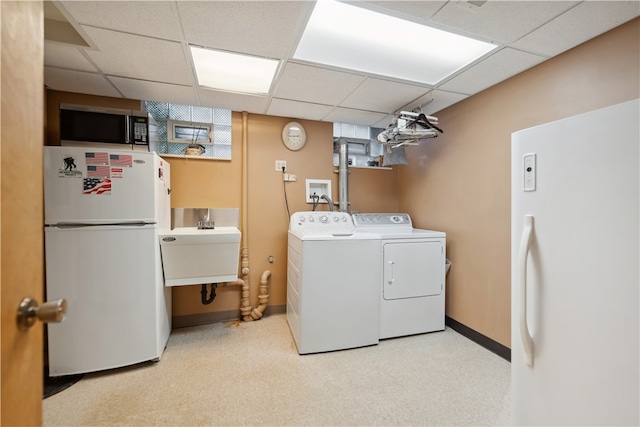 washroom featuring light carpet, sink, and independent washer and dryer