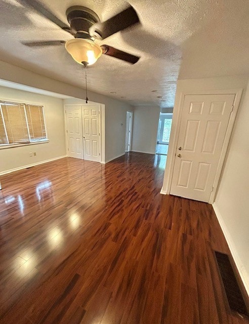 spare room featuring ceiling fan, a textured ceiling, and dark hardwood / wood-style floors