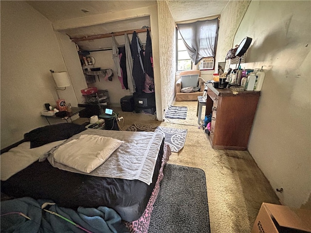 bedroom featuring light colored carpet and a closet