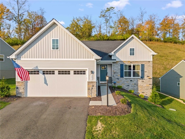 view of front facade featuring an attached garage, a shingled roof, stone siding, a front lawn, and board and batten siding