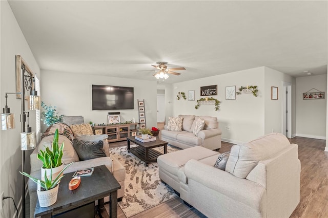 living room with hardwood / wood-style floors and ceiling fan