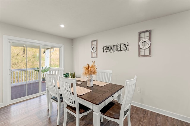 dining space with hardwood / wood-style floors