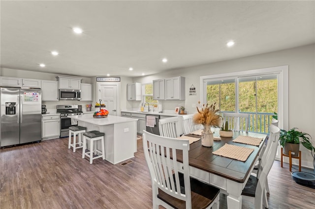 dining room with sink and dark wood-type flooring