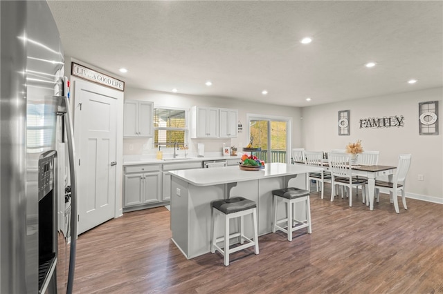 kitchen featuring hardwood / wood-style flooring, sink, a kitchen island, and stainless steel fridge with ice dispenser