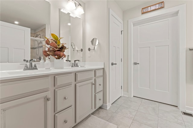 bathroom with vanity, tile patterned floors, and a shower with shower door