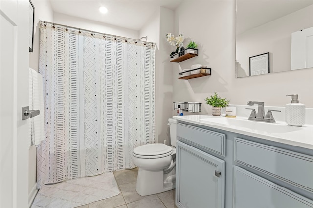 bathroom featuring vanity, toilet, and tile patterned flooring