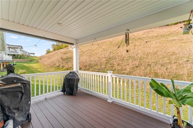 wooden deck featuring a yard and area for grilling