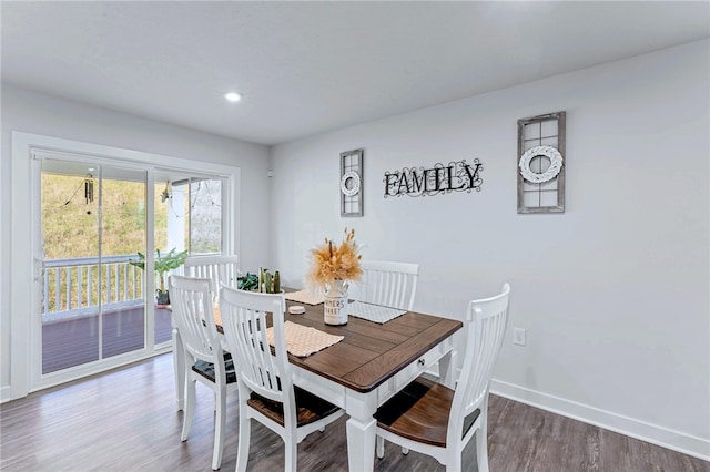 dining room with recessed lighting, baseboards, and wood finished floors