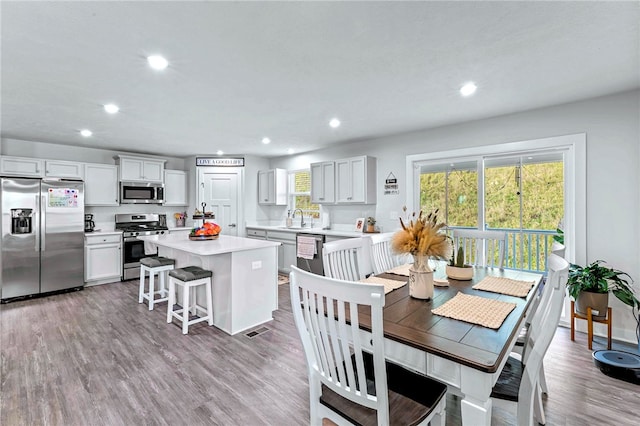 dining room with visible vents, wood finished floors, and recessed lighting