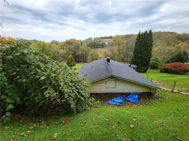 view of property exterior featuring a lawn